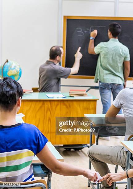 students passing notes to a friend - kids passing notes stock pictures, royalty-free photos & images