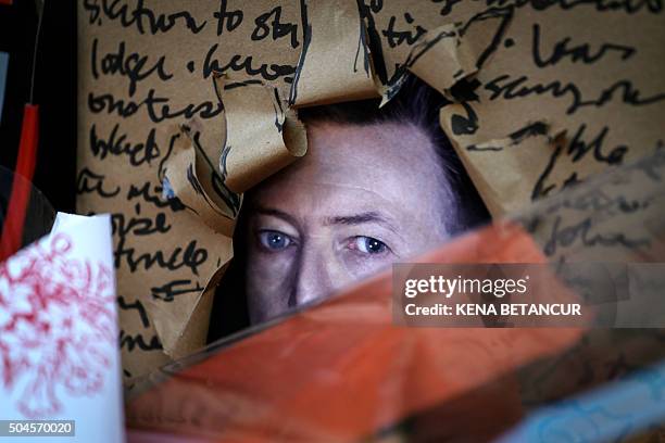 Poster is seen of British music legend David Bowie at a memorial outside of the residence in New York on January 11, 2016. Bowie has died at the age...