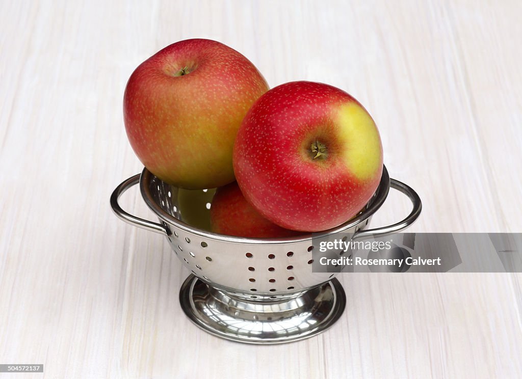 Pink lady apples ready to eat in colander