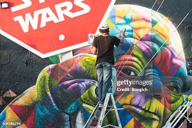 wynwood miami graffiti artist spray painting colorful mural - wynwood stock pictures, royalty-free photos & images