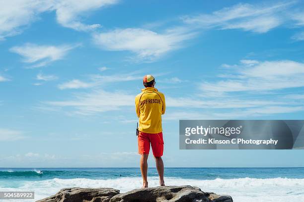 surf guard overlooking the ocean - rettungsschwimmer stock-fotos und bilder