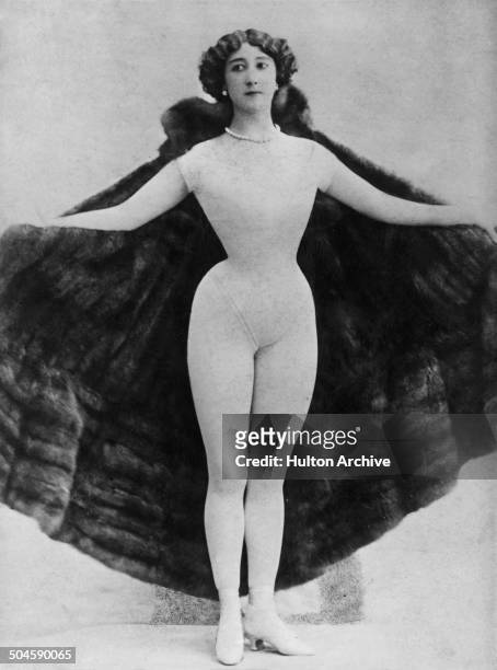 Spanish-born dancer, actress and courtesan, La Belle Otero wearing a fur cape over a body stocking, Paris, circa 1895.