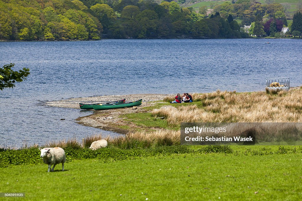 People relaxes on the lake shore.