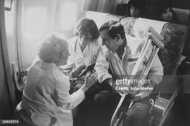 Exhausted survivors of United 747 flight 811, Diane Garber & friends William Perel and family aboard plane home after accident on United Airlines...