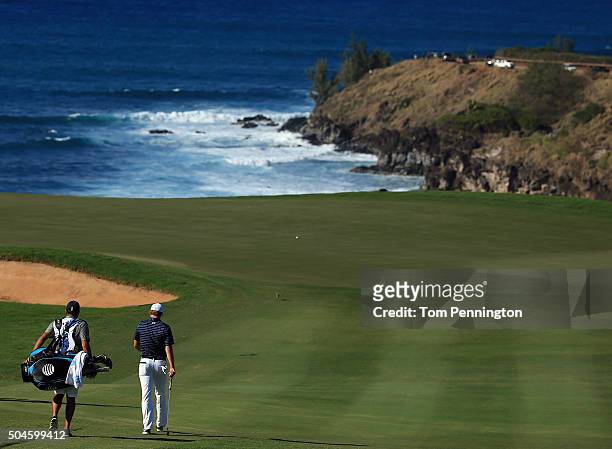 Jordan Spieth and caddie Michael Greller walk during the final round of the Hyundai Tournament of Champions at the Plantation Course at Kapalua Golf...