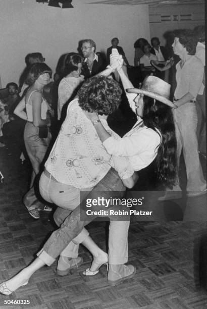 Good of singer/actress Cher Bono dancing w. Unidentified man at Studio 54.