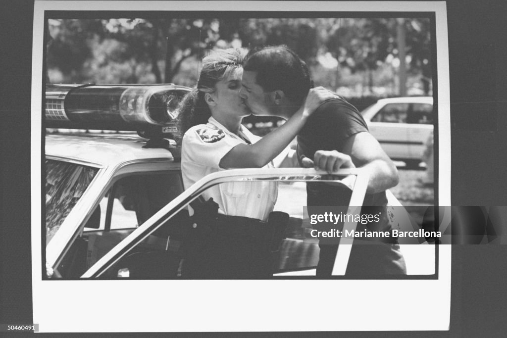 Deputy sheriff and actress Linda Canada kissing her fiance Jerry