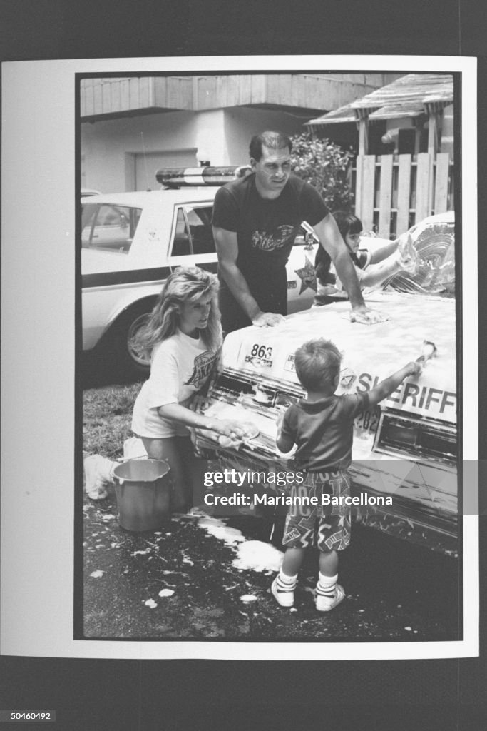 Deputy sheriff and actress Linda Canada washing her police car w