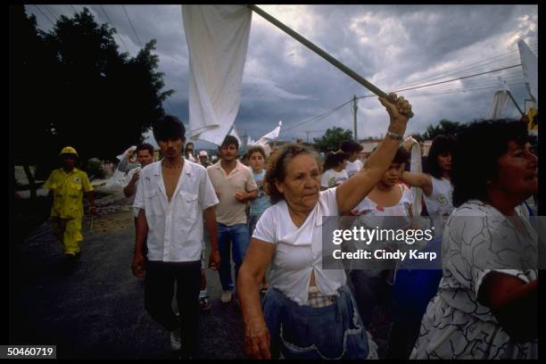 White flag waving civilians fleeing Soyapango area after govt. Forces bombed leftist guerrilla during major rebel offensive.