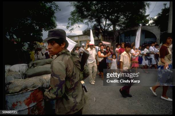 White flag waving civilians fleeing Soyapango area after govt. Forces bombed leftist guerrilla during major rebel offensive.