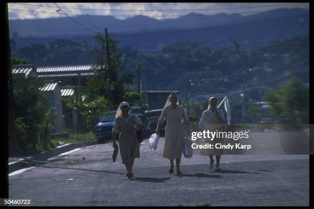 White flag waving nuns fleeing Soyapango area after govt. Forces bombed leftist guerrilla during major rebel offensive.