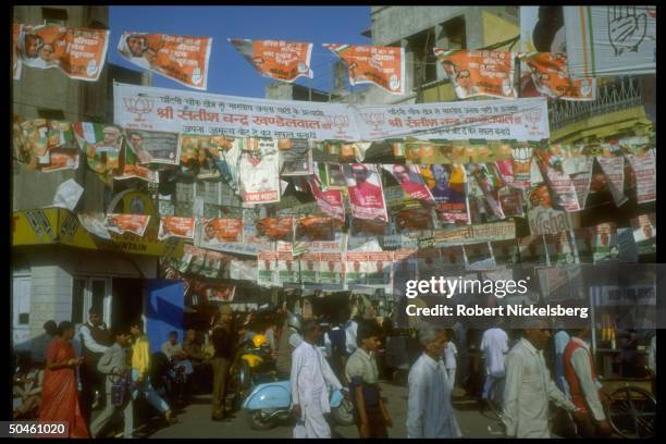 Street scene replete w. Parliamentary election campaign posters, incl. Touting Congress Party ldr. PM Rajiv Gandhi.