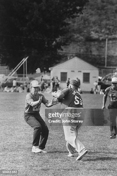 Old football player, Bud Costen prepares to tackle old running back, Dave Johnstone during the Codger Bowl football game, a 50 yr. Rematch using the...