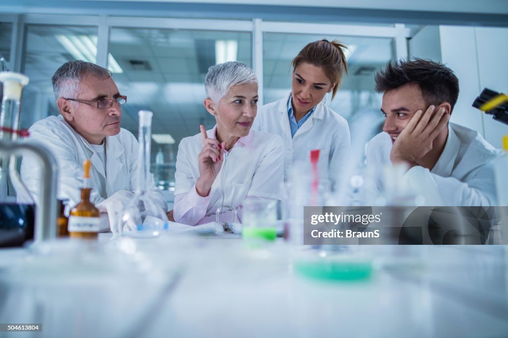 Group Lab Session Group Of Scientist Communicating On A Meeting In Laboratory High-Res ...