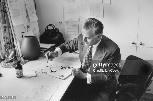 British shoe designer Manolo Blahnik working on sketches for new designs in his office.