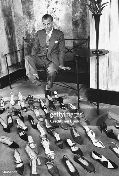 British shoe designer Manolo Blahnik with dozens of his shoes in his salon.