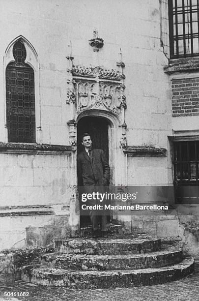 Nelson W. Aldrich Jr., born into upper crust family which lost its money; standing in doorway of ornate bldg during wild days in Paris, France.