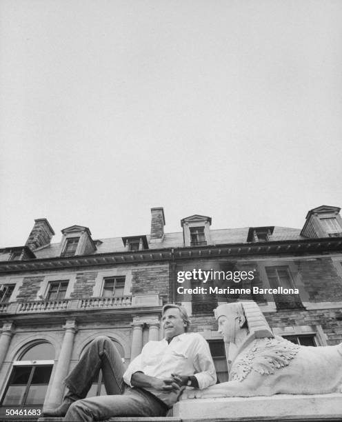 Nelson W. Aldrich Jr., born into upper crust family which lost its money; reclining on statue on steps of family mansion, now owned by Catholic...