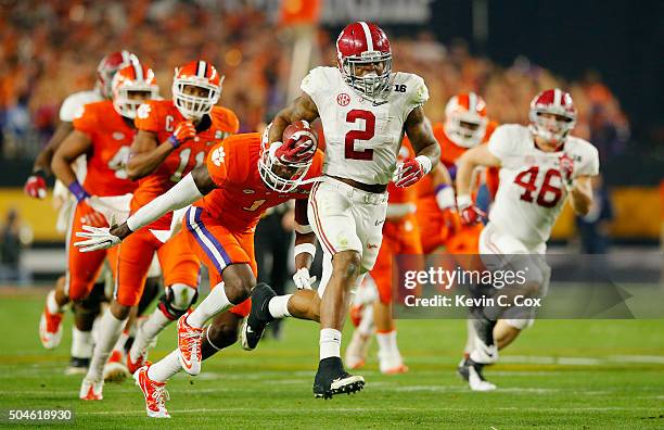 Derrick Henry of the Alabama Crimson Tide runs for a 50 yard touchdown in the first quarter against Jayron Kearse of the Clemson Tigers during the...