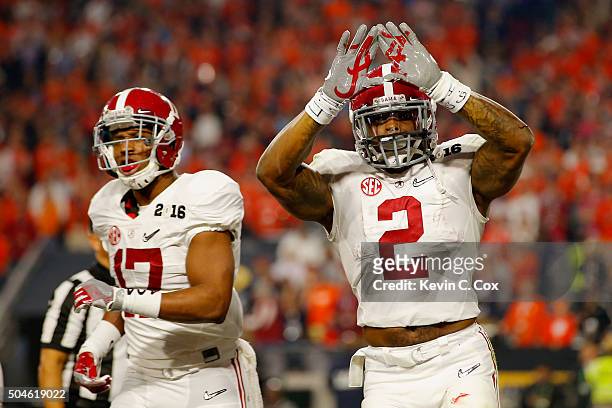 Derrick Henry of the Alabama Crimson Tide celebrates with teammate Kenyan Drake after scoring a 50 yard touchdown in the first quarter against the...