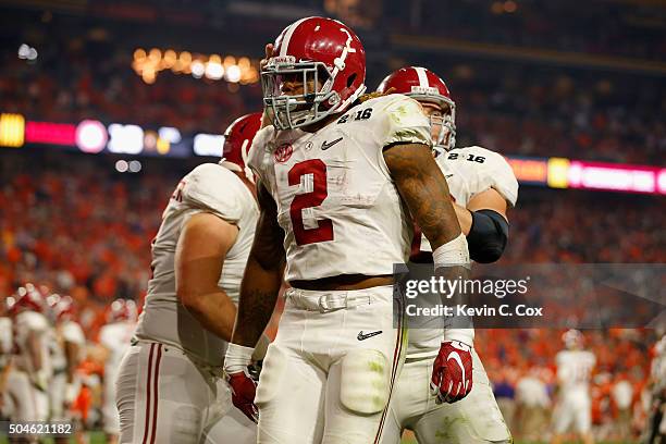 Derrick Henry of the Alabama Crimson Tide celebrates with his teammates after scoring a one yard touchdown in the second quarter against the Clemson...