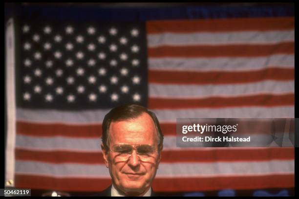 Pres. Bush poised against backdrop of American flag, appearing at fund-raiser for Sen. Mitch McConnell.