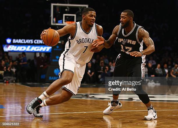 Joe Johnson of the Brooklyn Nets drives against Jonathon Simmons of the San Antonio Spurs during their game at the Barclays Center on January 11,...