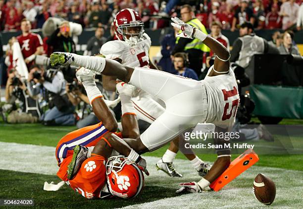 Artavis Scott of the Clemson Tigers attempts to catch an end zone pass broken up by Ronnie Harrison of the Alabama Crimson Tide in the third quarter...