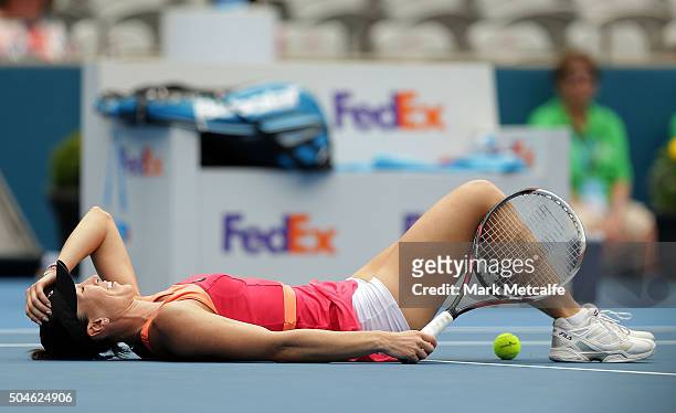 Jelena Jankovic of Serbia falls to the ground during a point in her match against Sara Errani of Italy during day three of the 2016 Sydney...