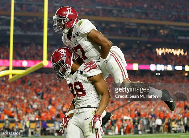 Howard of the Alabama Crimson Tide celebrates with his teammate Kenyan Drake after scoring a 51 yard touchdown in the fourth quarter against the...