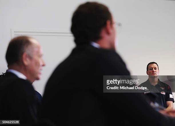 Essendon Bombers coach John Worsfold listens to Bombers CEO Xavier Campbell and Chairman Lindsay Tanner speak to media at a press conference at the...