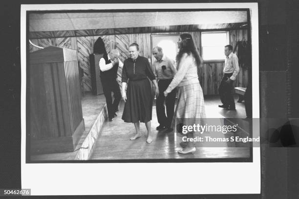 Church leader, Dewey Chafin conducting members Jeanette Kennedy, Ray McCallister & Georgia Mullins in trance-like dance before the snake handling...