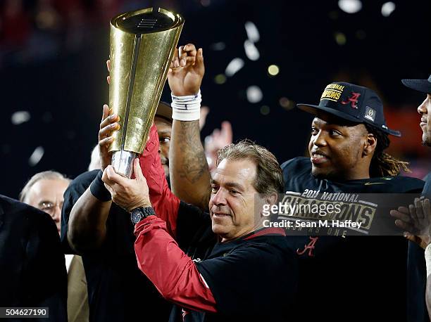 Head coach Nick Saban of the Alabama Crimson Tide celebrates by hoisting the College Football Playoff National Championship Trophy after defeating...