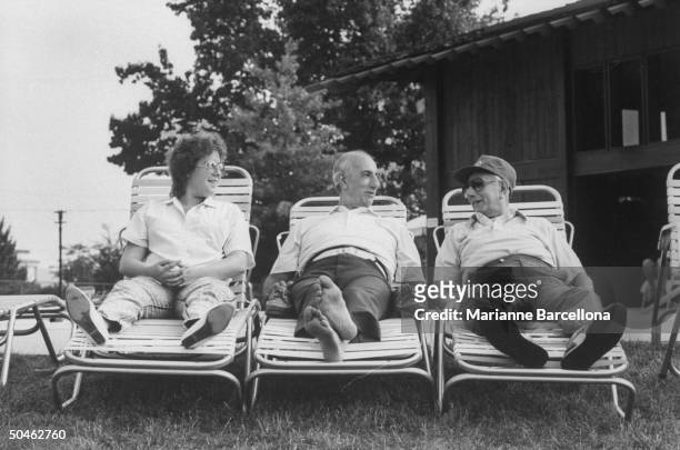 Clown prince of baseball Max Patkin reclining on lawn chair between his brother Eddie & daughter Joy in backyard of home.