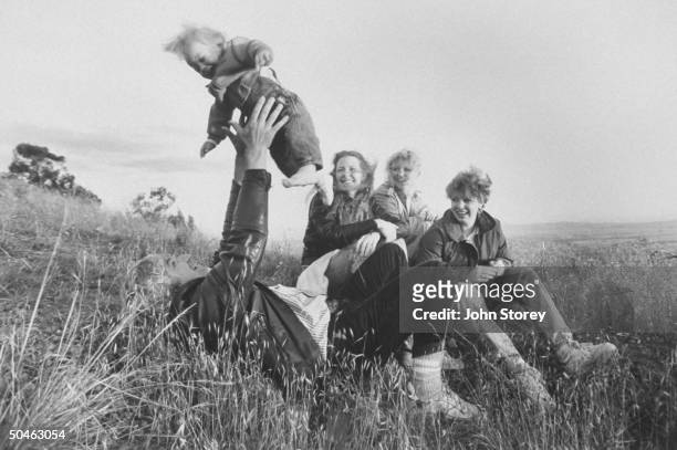 Family of Thomas Sutherland, kidnapped by Islamic Jihad in 1985 Ray Keller holding baby, Simone, Joan & Kit Sutherland & Ann, Ray's wife; on grassy...