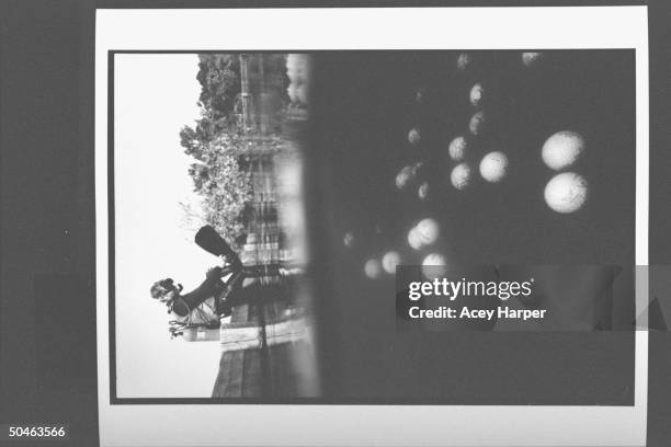 Golf ball diver Jim Reid wearing scuba gear, sitting on edge of a golf course pond, adjusting his flippers as he prepares to gather stock for Second...