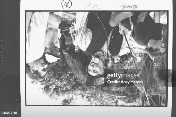 Actor Charlton Heston in costume as Long John Silver holding a saber, looking over his shoulder at son, Fraser , who is directing him in TREASURE...