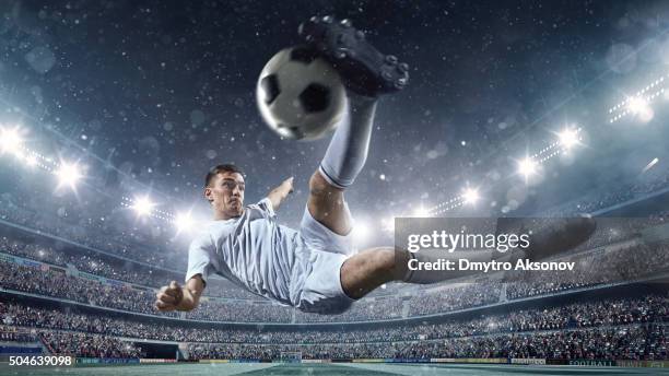 soccer player kicking ball in stadium - kicking football stock pictures, royalty-free photos & images