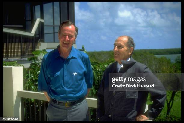 French Pres. Francois Mitterrand chatting w. Pres. Bush at Pelican Pt.