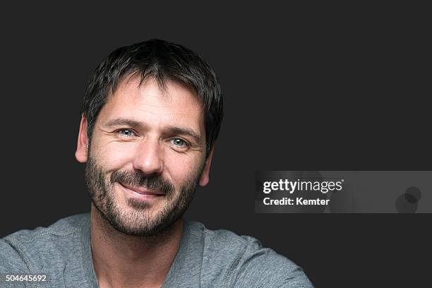 charming smiling man portrait isolated on gray - male blue eyes stock pictures, royalty-free photos & images