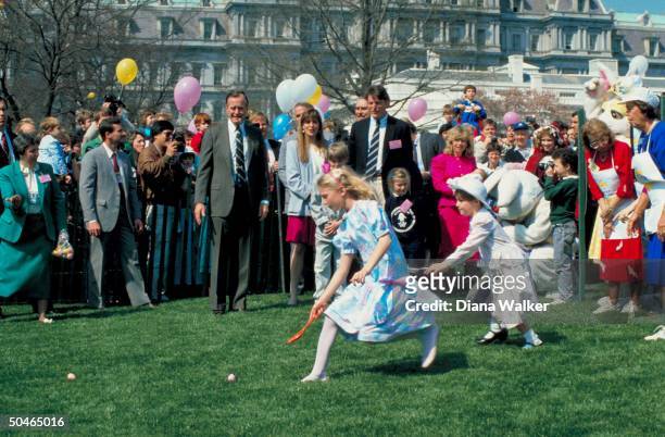 Pres. Bush playing whistle master, hosting WH lawn easter egg roll, w. Daughter-in-law Sharon & baby Ashley et al incl. Actor Reeve .