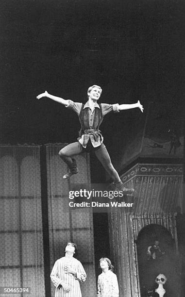 Actress Sandy Duncan flying across stage, as actors Alex Winter and Jonathan Ward watch, during performance of Peter Pan.