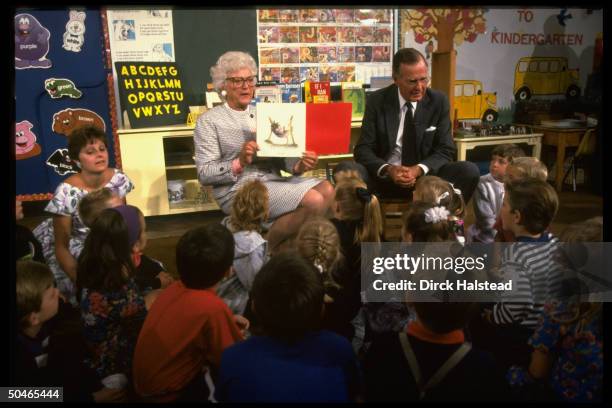 Pres. & Barbara Bush entertaining young audience, displaying artwork, imparting lesson in culture, paying classrm. Call, at elementary school in...