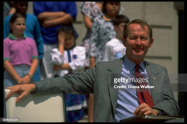 Education Secy. Lamar Alexander framed by kids during fete attended by Pres. Bush on St. Paul Public Library grounds.