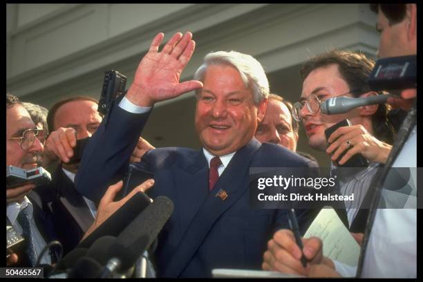 Beaming Russian Pres. Boris Yeltsin waving, pausing while speaking w. Press outside WH after mtg. W. Pres. Bush.