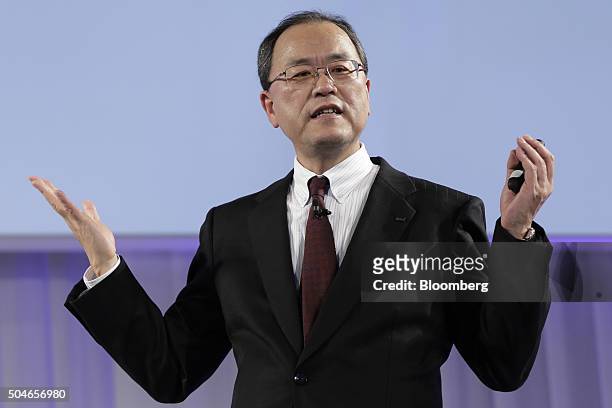 Takashi Tanaka, president of KDDI Corp., gestures as he speaks during the unveiling of the company's new products and services in Tokyo, Japan, on...