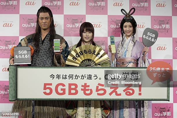 Actor Kenta Kiritani, left, actress Kasumi Arimura, center, and model and actress Nanao pose during a photo session at the unveiling of KDDI Corp.'s...