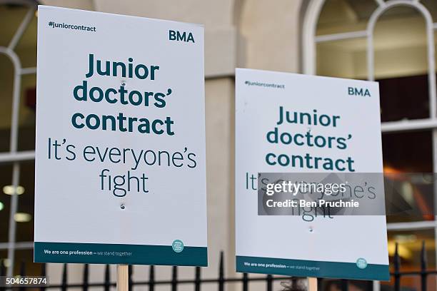 Demonstrators hold banners with the slogan "Junior doctors contract it's everyone's fight" outside Guy's hospital as junior doctors stage a 24-hour...