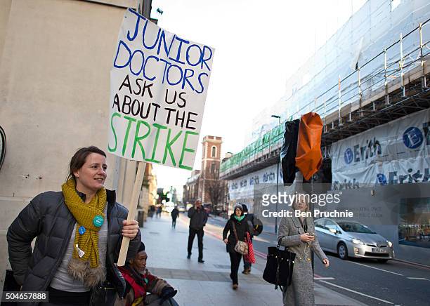 Junior doctor holds a banner with the slogan "Junior doctors ask us about the strike" outside Guy's hospital as junior doctors stage a 24-hour strike...