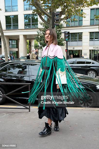 Fashion editor for Vogue Ukraine Julie Pelipas wears a Marianna Senchina jacket, Balenciaga boots and a Zac Posen bag on day 9 during Paris Fashion...